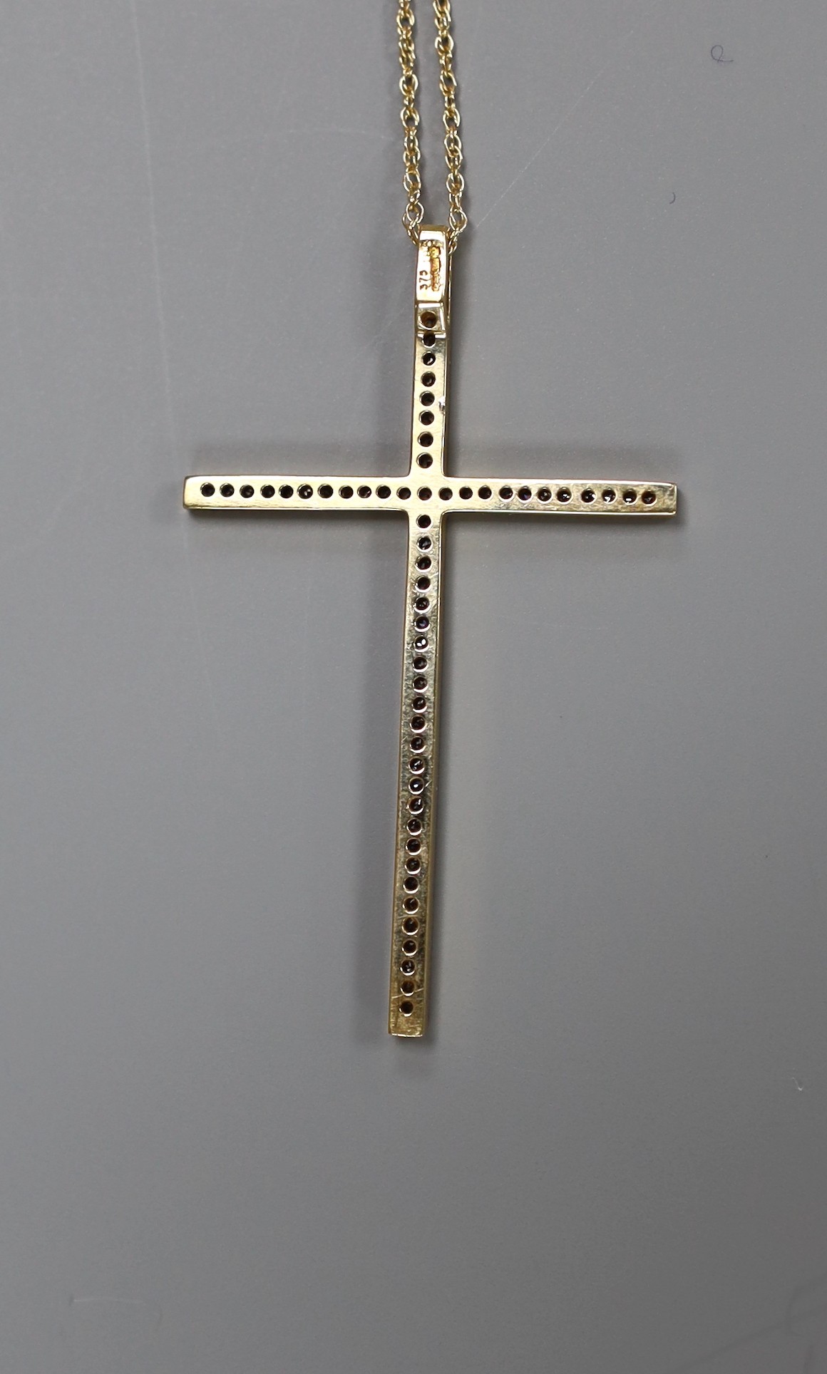 A modern 9ct gold and diamond cluster set cross pendant, 49mm, on a 9k fine link chain, 40cm, gross weight 4 grams.